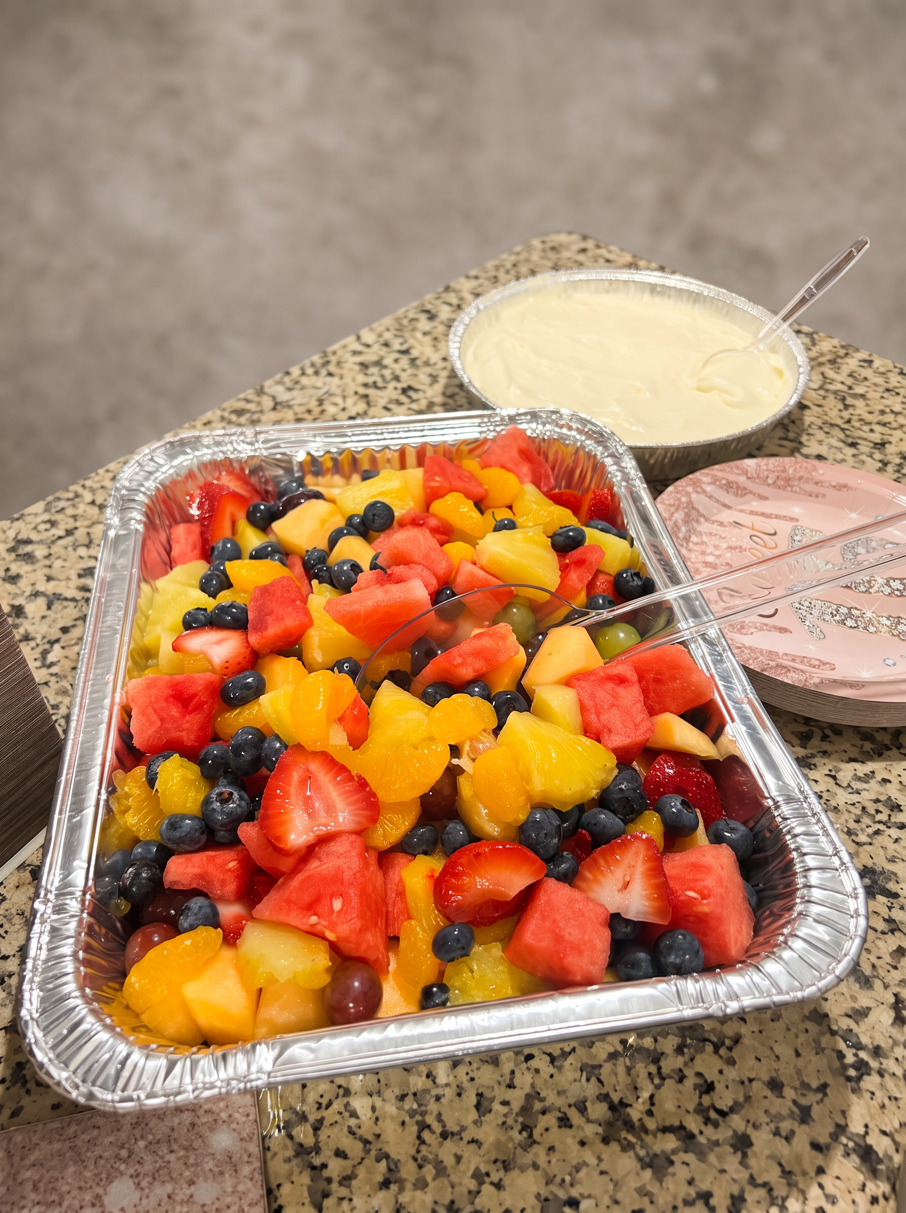 Fresh fruit salad with strawberries, watermelon, pineapple and blueberries with cream dressing